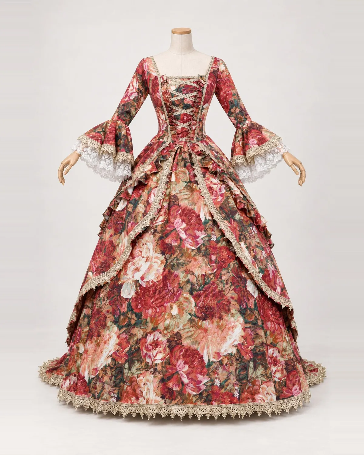 Bouquet Fauve — Red Floral Gown with Lace-Edged Overskirt — shown on a mannequin, front product view