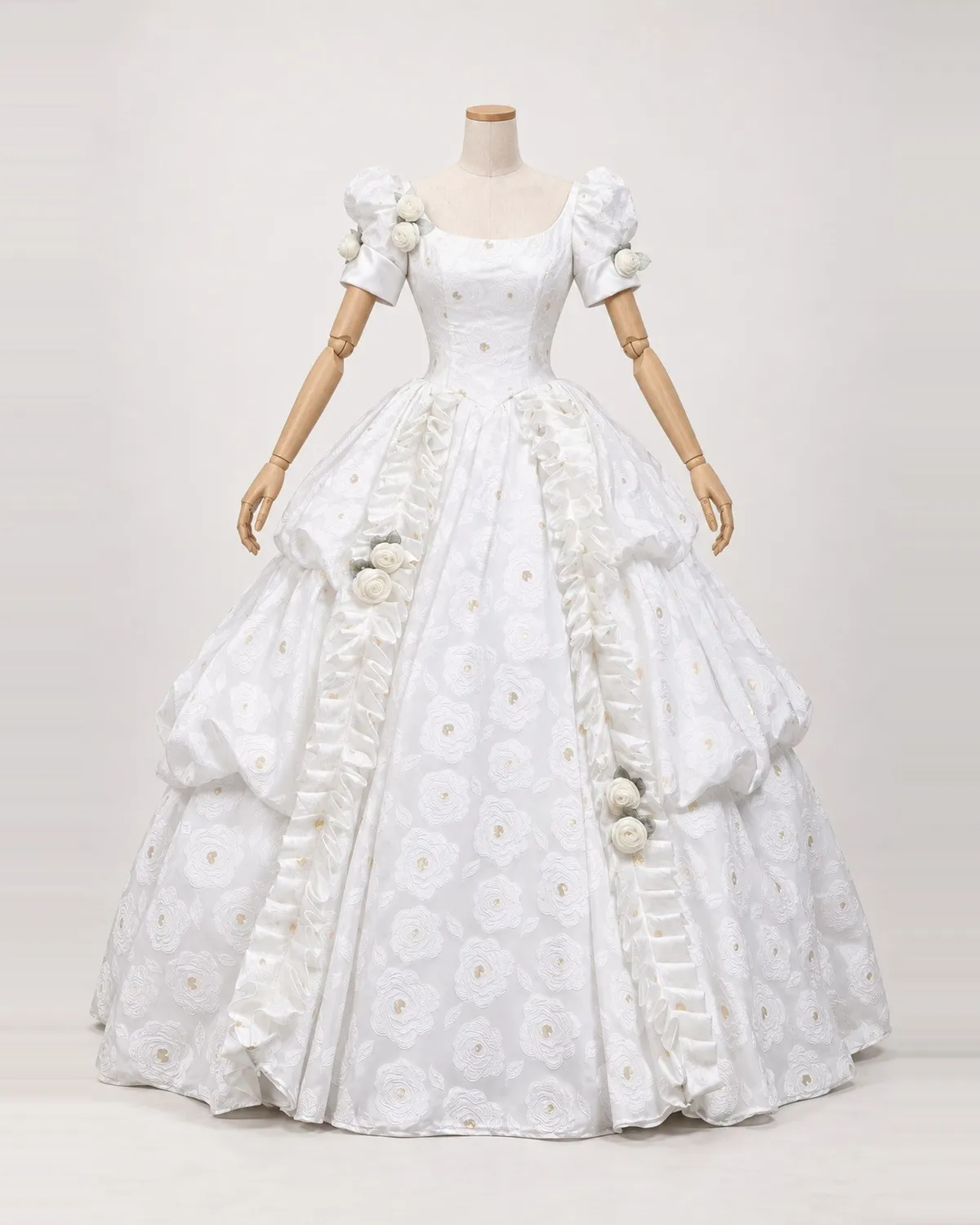 Camélia Blanche — White Floral Ball Gown with Rosette Drapes — shown on a mannequin, front product view