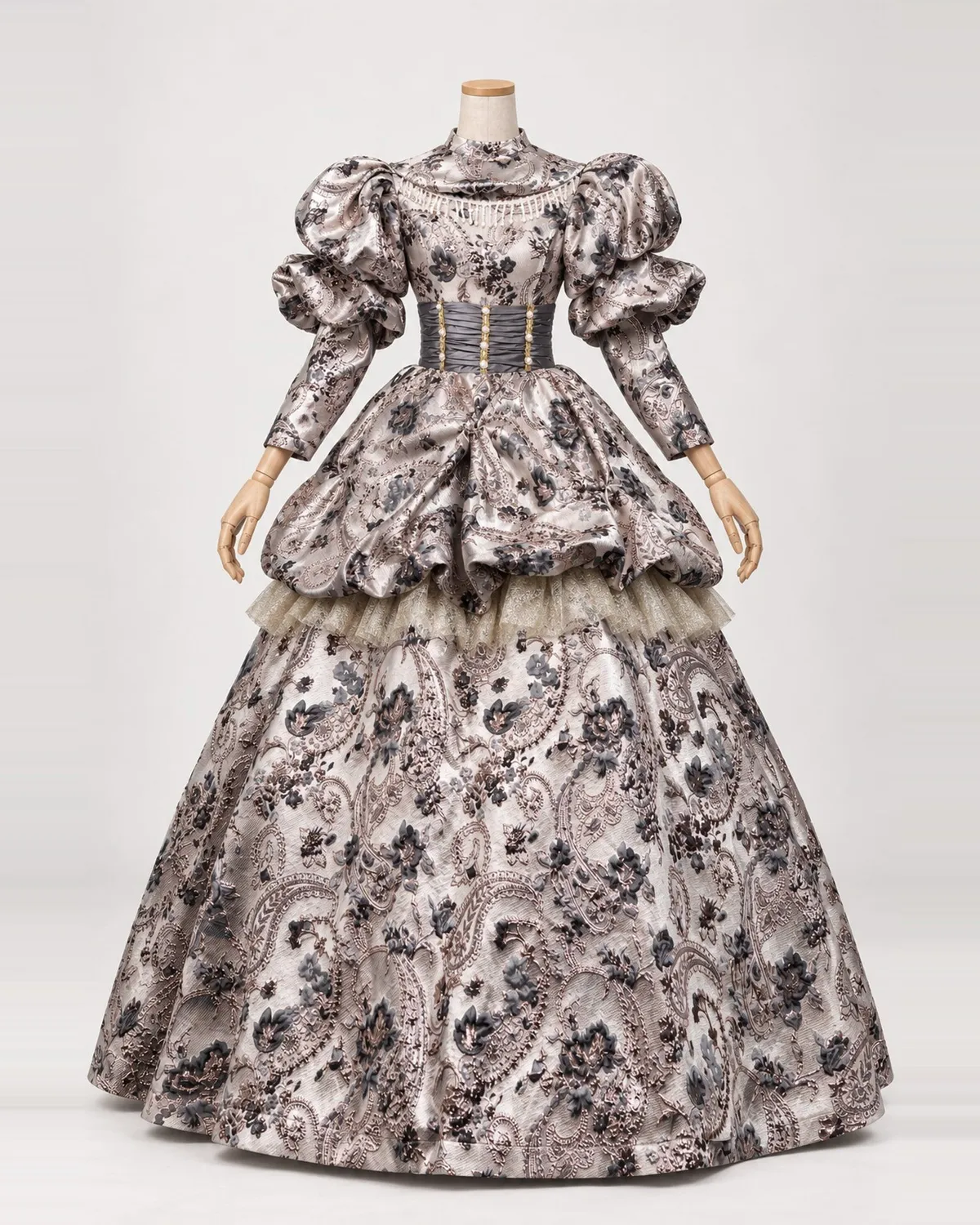 Élise Fumée — Champagne-Grey Floral Gown with Puffed Peplum — shown on a mannequin, front product view