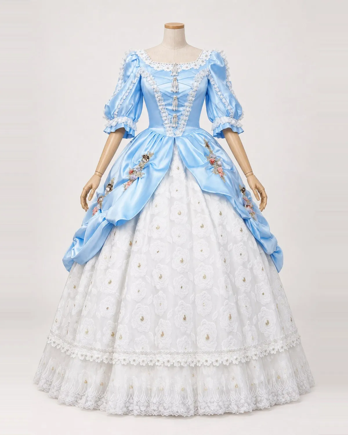 Floriane Bleue — Sky Blue Gown with White Rosette Skirt and Floral Swags — shown on a mannequin, front product view