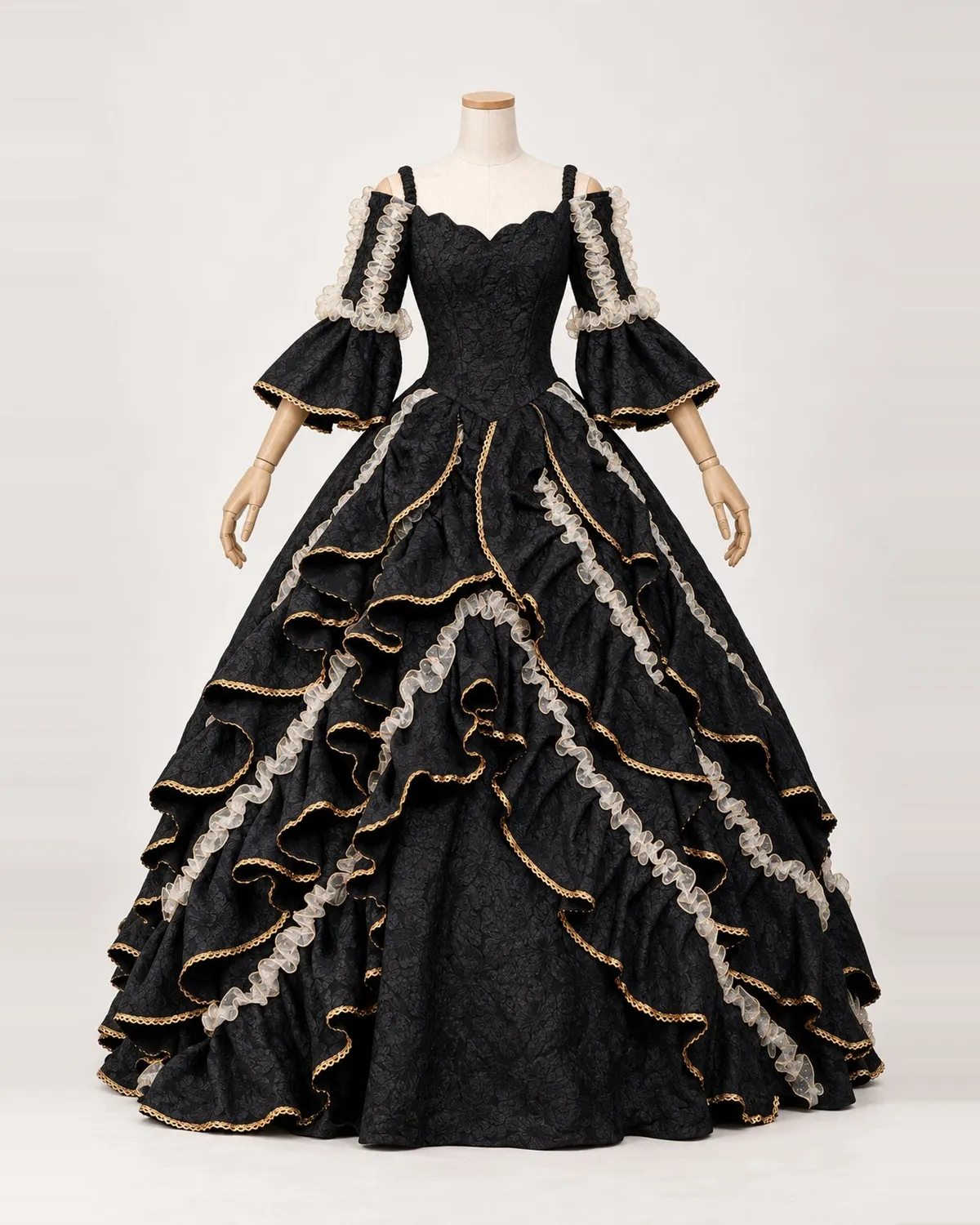 Opéra Noir black and gold lace-tiered ball gown on a mannequin, front product view